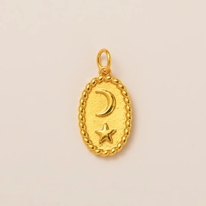 Detail of 18K gold crescent moon and star oval pendant with textured finish