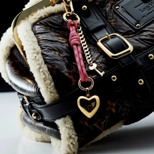 Elegant pink braided knot bag charm with golden heart locket and key accessory