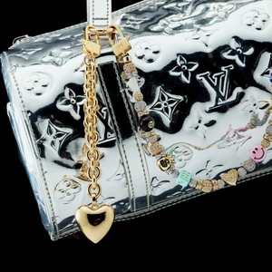 Chic gold chain bag charm with colorful beads and heart pendant on silver handbag