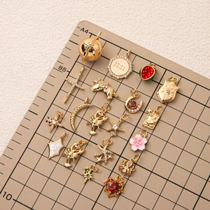 Selection of gold-plated charms including celestial stars and 11:11 angel number pendant