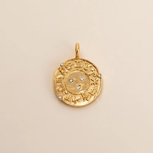 Detail of 18K gold-plated zodiac coin pendant featuring Roman numeral II and inlaid zircons
