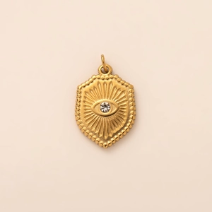 Close-up of 18K gold plated evil eye pendant with zircon stone and sunburst texture