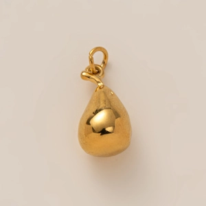 Close-up of a minimalist golden water drop pendant with polished metallic luster