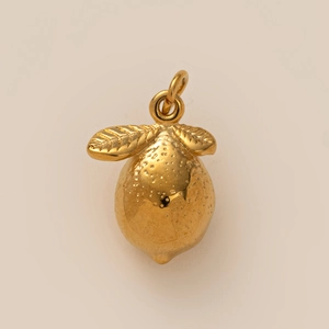 Detailed view of a gold-plated lemon pendant with textured peel and delicate leaf accents