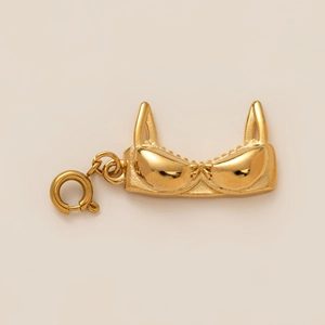 Detailed close-up of a high-polish gold underwear-shaped pendant for jewelry