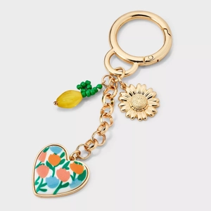 Detailed macro view of 18K gold plated keychain with tulip heart and sunflower pendants