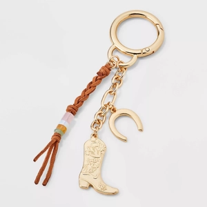Detailed macro view of 18K gold plated Western keychain with cowboy boot and horseshoe