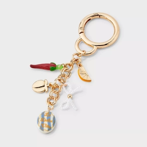 Detailed close-up of 18K gold-plated charms including lemon, chili, and La Dolce Vita pendant