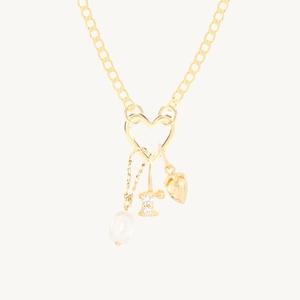 Detailed close-up of 18K gold-plated heart pendant with pearl, strawberry, and L letter charm