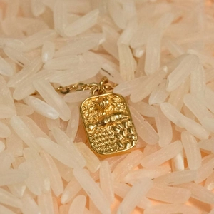 Gold plated stainless steel rectangular pendant with embossed texture on a fine chain