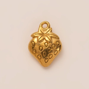 Detailed view of a golden strawberry pendant with textured seeds and embossed leaf detail