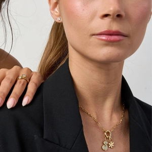 Detailed view of 18K gold plated S-letter pendant necklace and zircon ring on model