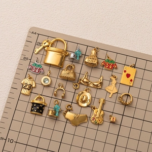 DIY stainless steel 18K gold plated charms including keys and bags on grid mat