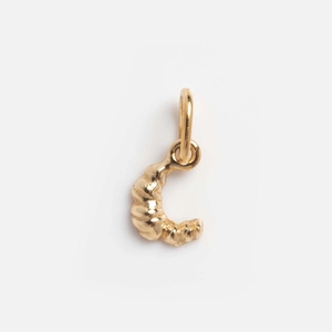 Detailed view of a 14K gold-plated croissant-style pendant with a polished metallic finish