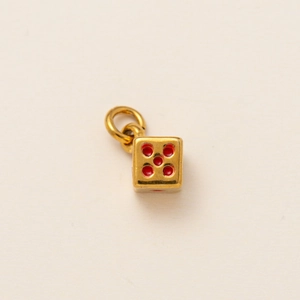 Macro shot of 18K gold plated dice pendant with red enamel dots and metal jump ring