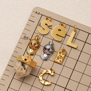 DIY 18K gold plated stainless steel letter and baseball cap charms on a grid board