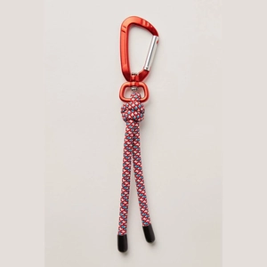Close-up of a red aluminum carabiner with a durable red, white, and blue braided nylon rope