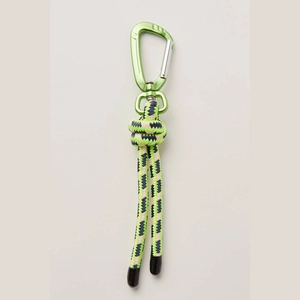 Detail of light green D-ring carabiner and thick woven cord with navy wave pattern