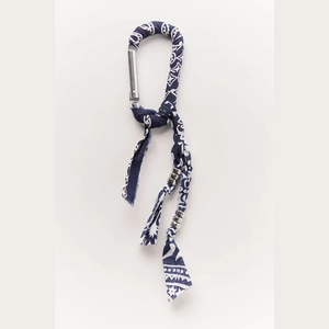 Detail of bohemian blue floral fabric wrap and metal beads on silver carabiner keychain