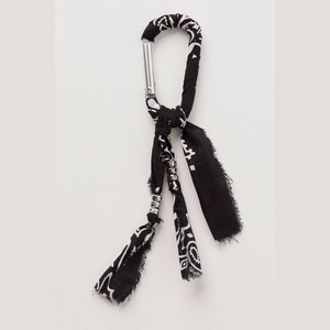Detail of silver D-ring keychain with black and white bandana fabric and metal beads