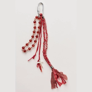 Ethnic style keychain with red beads, woven rope, brown tassels and a silver cross pendant