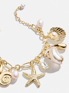 Detailansicht von 18K Gold-Seestern- und Muschel-Anhängern mit Perle und Edelsteinbesatz