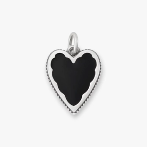 Close-up of heart pendant with black onyx inlay and 18K gold plated beaded edge