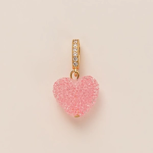 Pink heart pendant with shimmering texture and gold-plated bail set with clear zircons