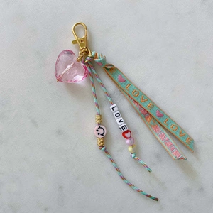 Detail of pink heart charm keychain with 14K gold lobster clasp and LOVE ribbon