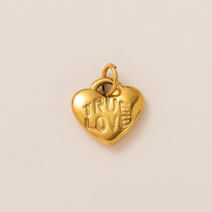 Detailed view of heart-shaped 18K gold-plated pendant with TRUE LOVE relief engraving
