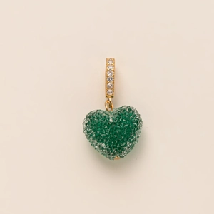 Detailed view of emerald green heart pendant with gold plating and white zircon accents