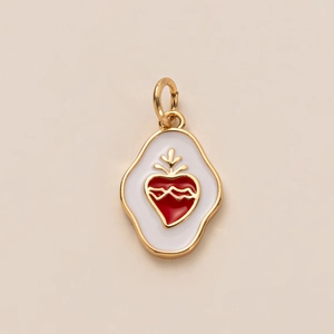 Macro shot of white enamel heart pendant with gold wave pattern and gold-plated borders