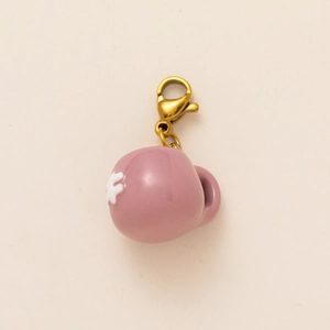 Vista dettagliata del ciondolo smaltato rosa con fiore bianco e chiusura dorata 18K