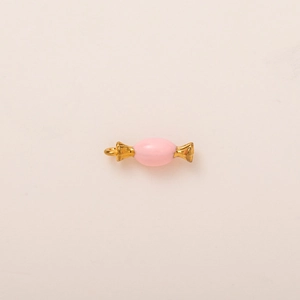 Macro shot of candy-shaped pink enamel pendant with 18K gold plated metal ends and loop