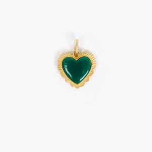 Detail of a gold plated heart pendant with deep green stone and sunburst textured border