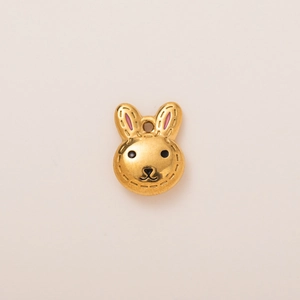 Detailed view of an 18K gold plated rabbit charm with pink ears and black facial features