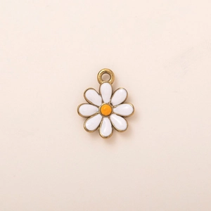 Detail view of 18K gold plated daisy flower pendant with white enamel petals for DIY jewelry