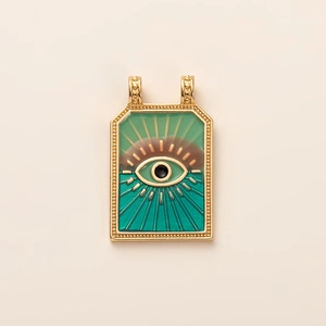 Detailed macro view of 14K gold plated rectangular tarot pendant with evil eye enamel