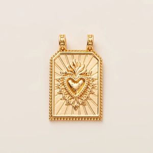 Close-up of 14K gold plated Tarot pendant with sacred heart and radiant sunbeams