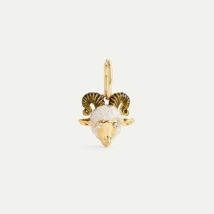 Macro detail of 18K gold ram head pendant with white enamel finish and zircon eyes
