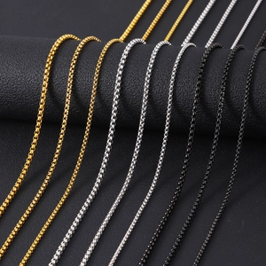 Detail of stainless steel box chain necklaces in gold, silver and gun black finishes