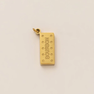 Detailed close-up of a 18K gold plated bourbon biscuit shape pendant with engraved text