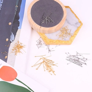 Assorted DIY jewelry ball pins in gold, silver, and gunmetal finishes on a tray