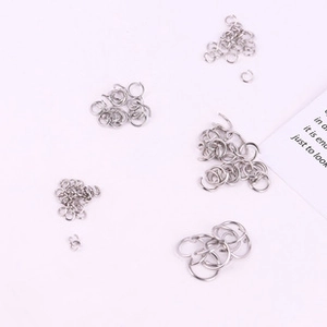 Detailed view of various sizes of silver stainless steel jump rings for DIY jewelry making