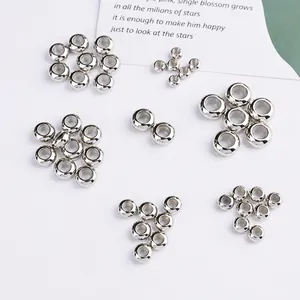 Close-up of shiny silver large-hole spacer beads for handmade DIY jewelry making