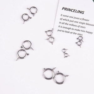 Macro view of various sized polished silver spring ring clasps for DIY jewelry making