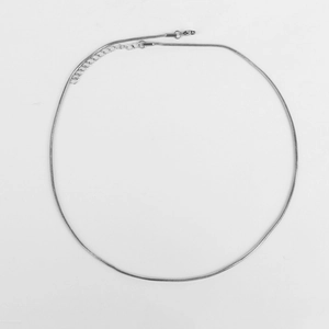 Detail of silver round snake chain necklace with lobster clasp and adjustable extension link