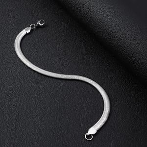 Detailed macro view of silver flat snake chain texture with a secure lobster clasp