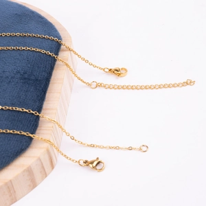 Close-up of gold stainless steel cable chain with lobster clasp and extender link