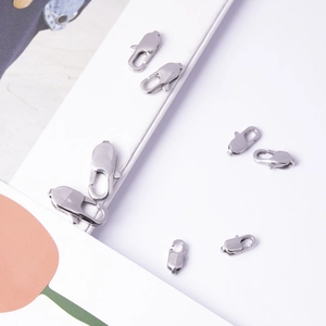 Detailed macro view of various sizes of polished stainless steel lobster clasps for DIY jewelry